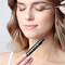Thumbnail of a woman applying eyelash serum looking down
